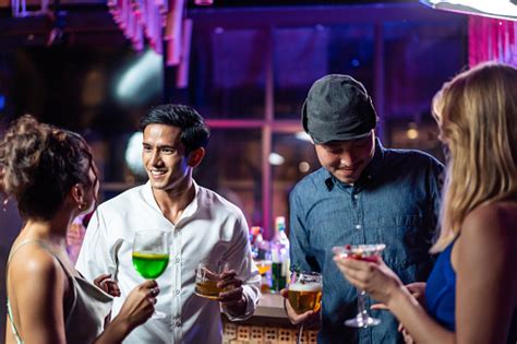 Emberek együtt isznak és szórakoznak egy bárban